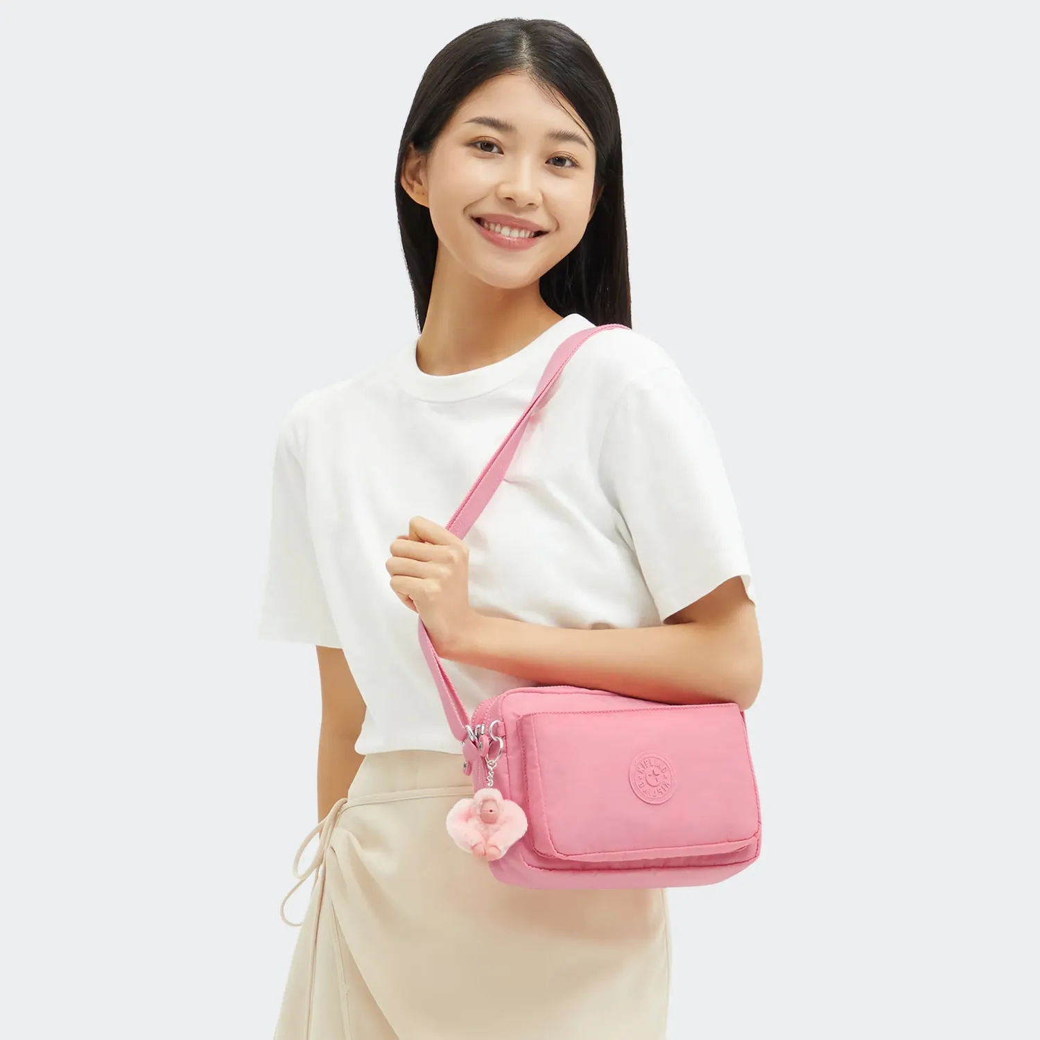 Kipling Abanu M crossbody tas Enjoyable Blush medium met ritsvakken