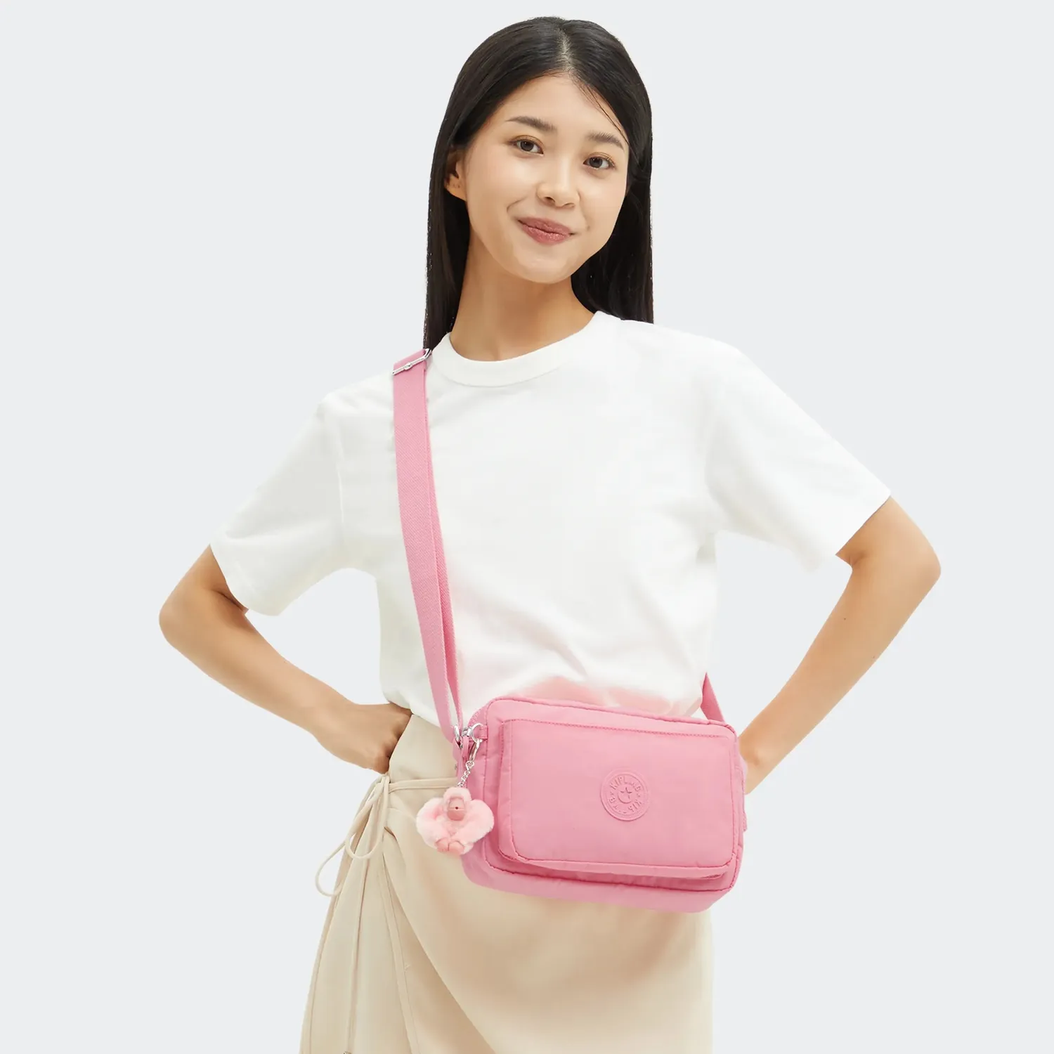 Kipling Abanu M crossbody tas Enjoyable Blush medium met ritsvakken