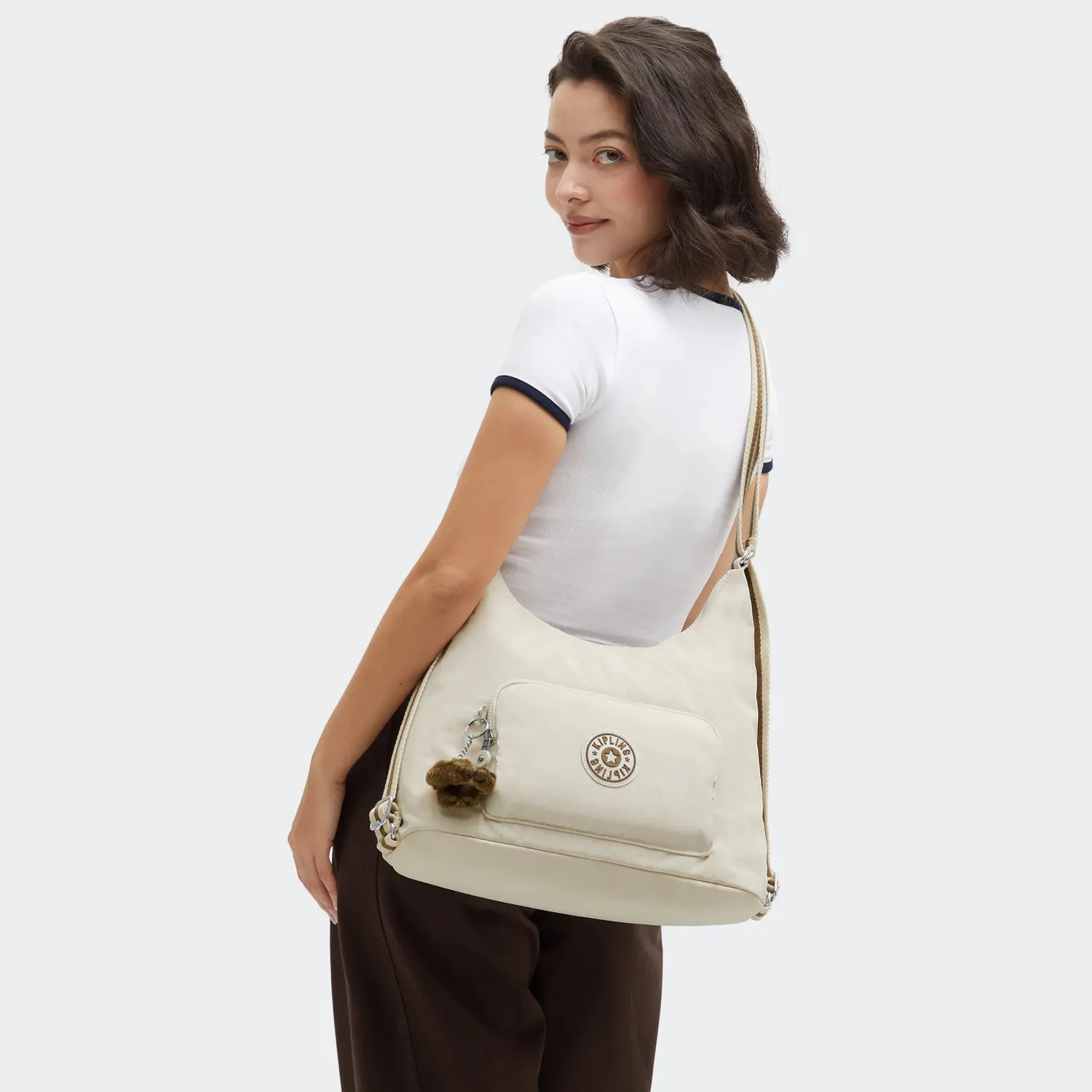 Kipling Yenna schoudertas Soft Sand medium multifunctioneel