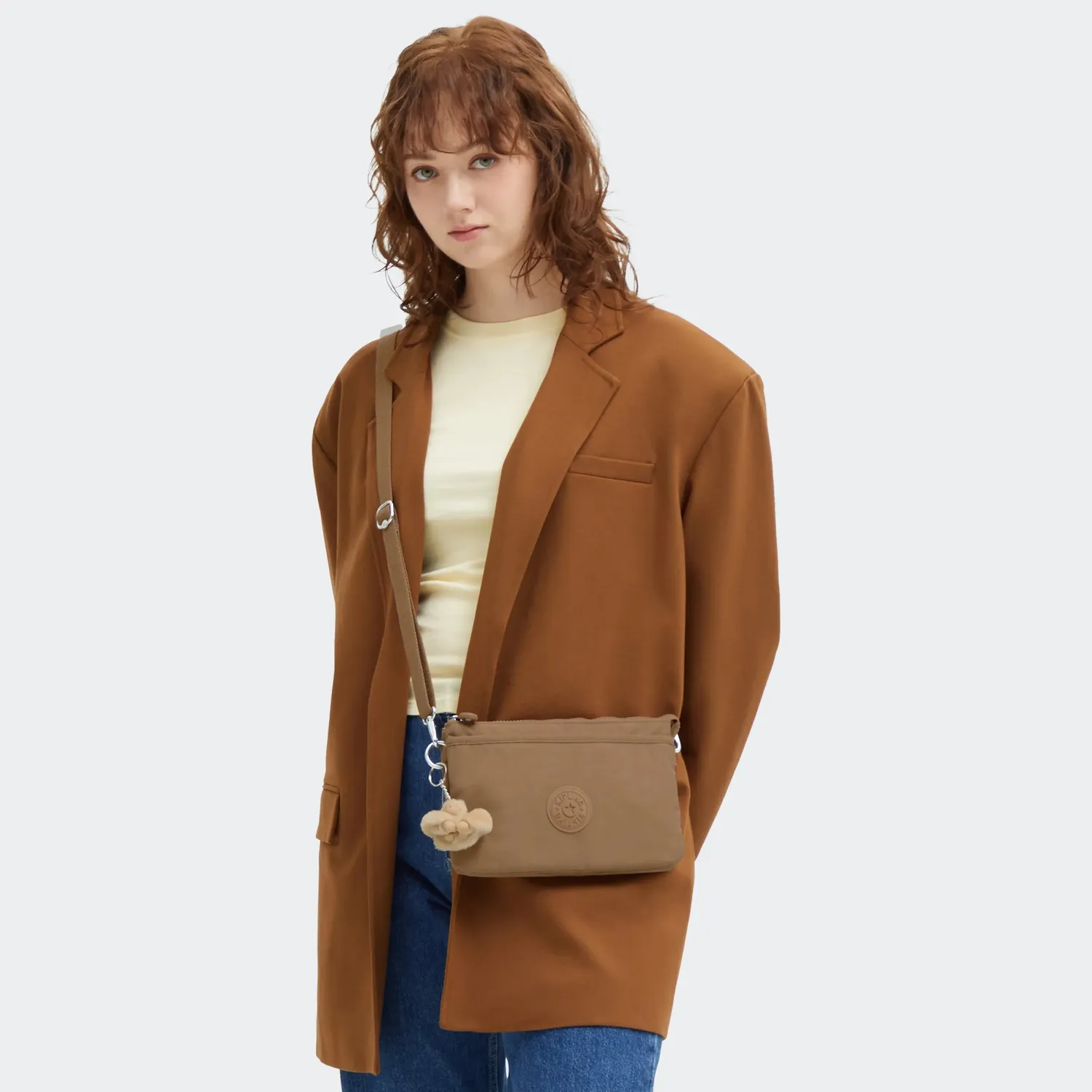 Kipling Riri crossbodytas Klein Early Tan lichtgewicht